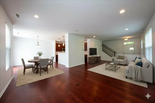 a living room with furniture and wooden floor