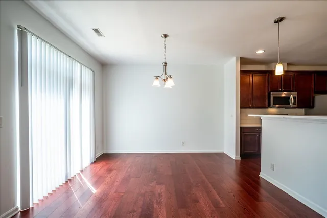 a view of a kitchen with a sink wooden floor and a window