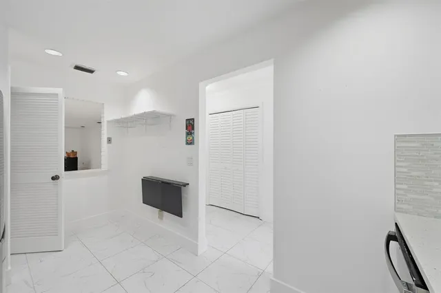 a view of an entryway with wooden floor