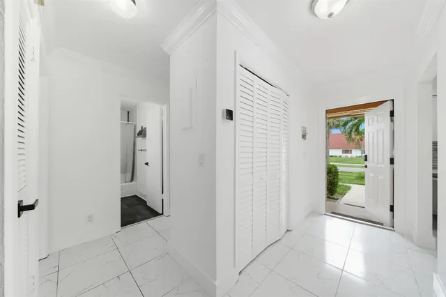 a view of a hallway with wooden floor