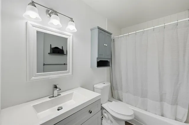 a view of a ceiling fan and hardwood floor