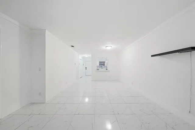 a open kitchen with white cabinets and white appliances