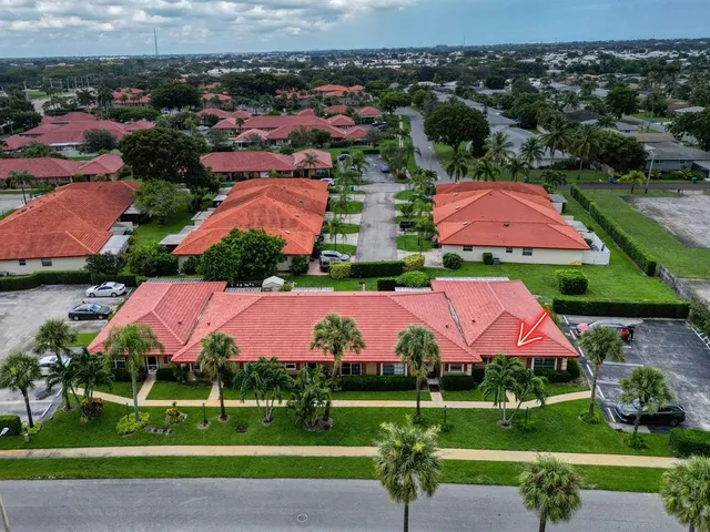 an aerial view of a house with a garden and lake view