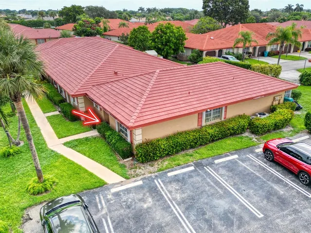 a aerial view of a house with a yard and potted plants