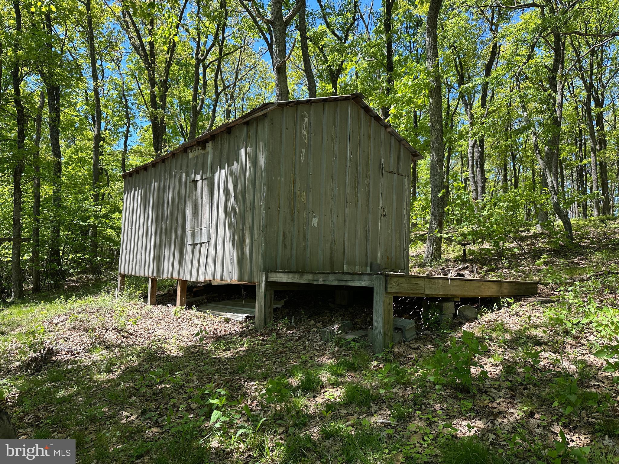 181 Deer Run Road Baker, WV 26801 - Photo 38 of 71 a backyard of a house with large trees and wooden fence