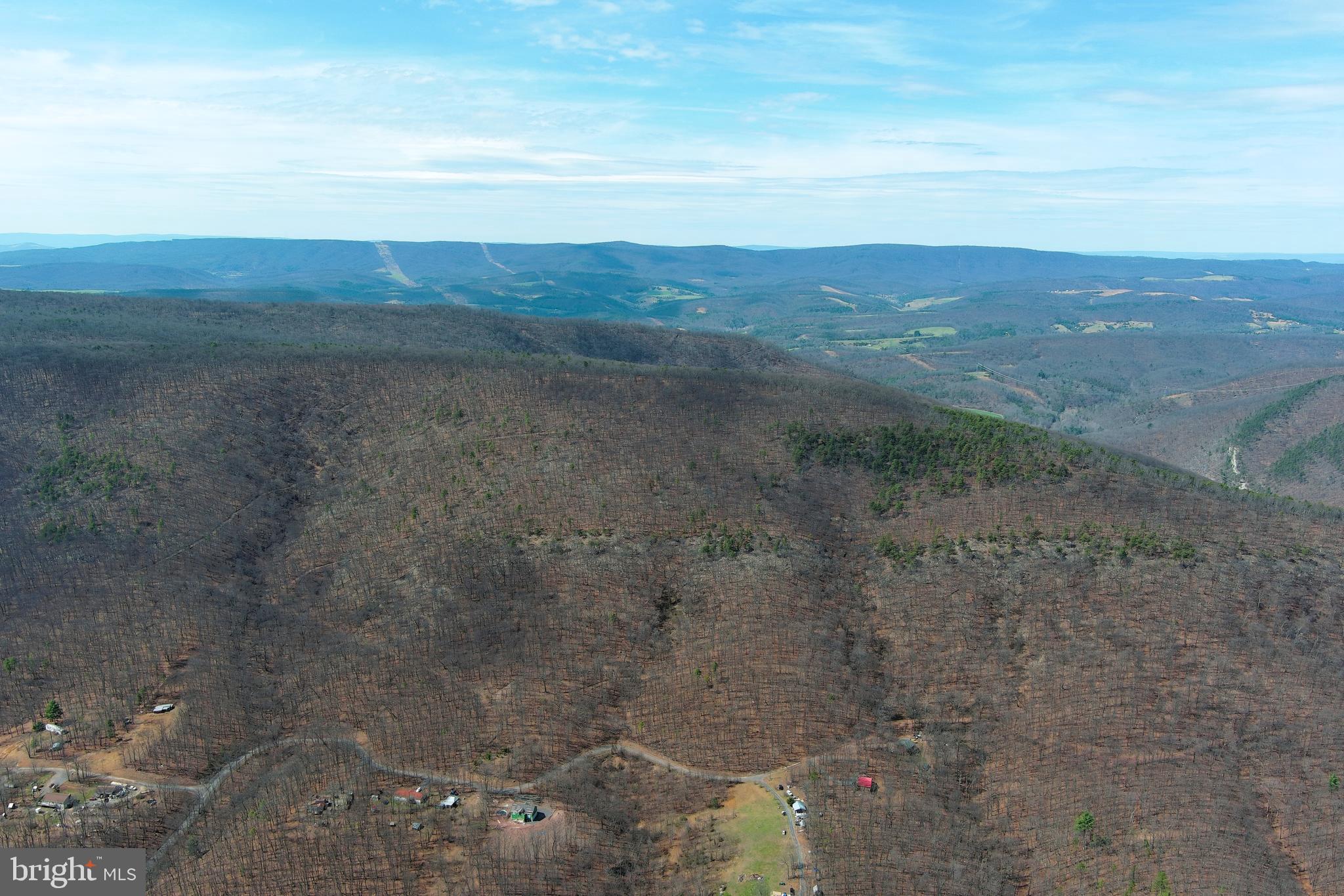 181 Deer Run Road Baker, WV 26801 - Photo 45 of 71 a view of a dry yard with mountains in the background
