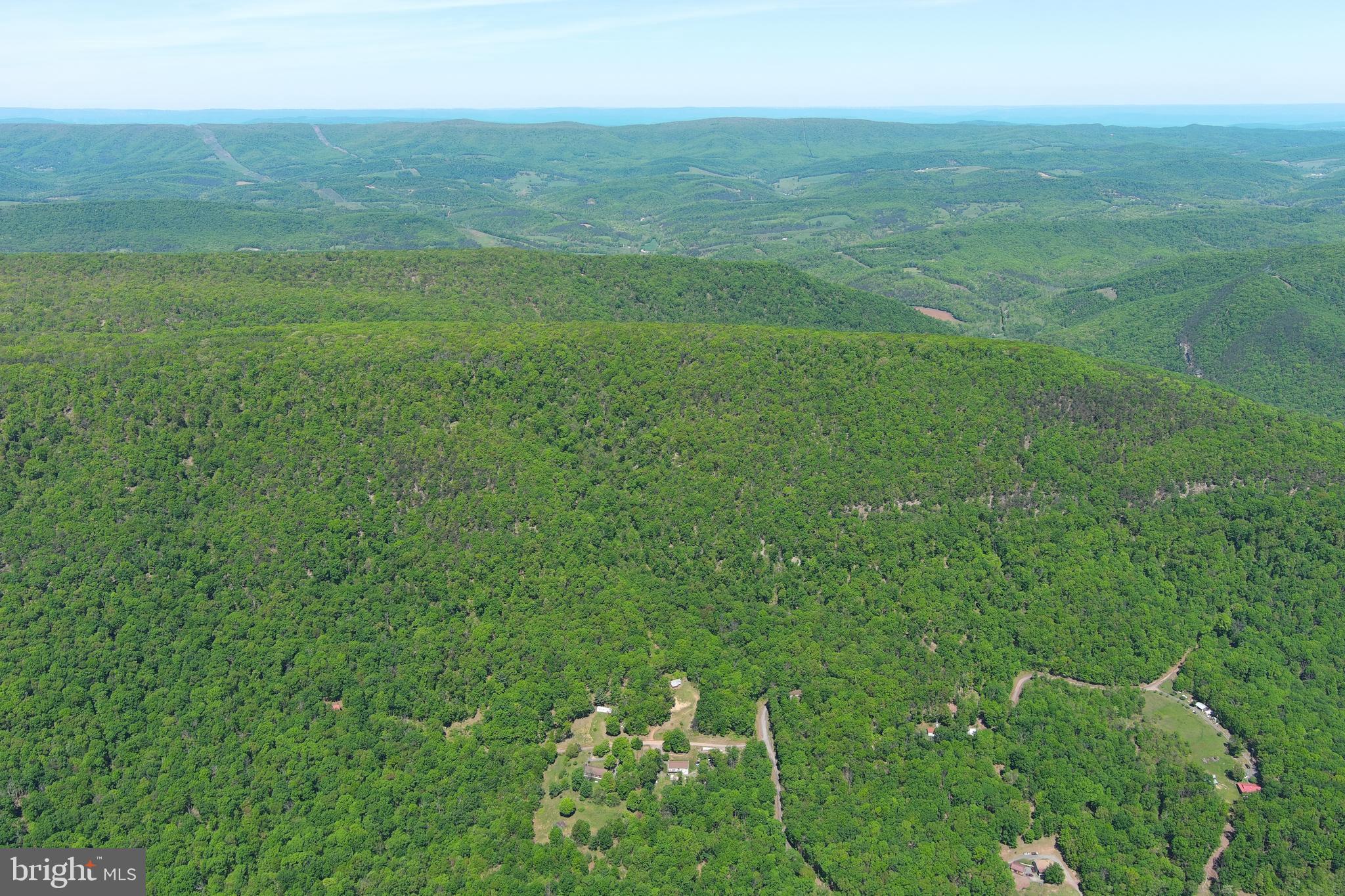 181 Deer Run Road Baker, WV 26801 - Photo 59 of 71 a view of a big yard with an outdoor space and seating