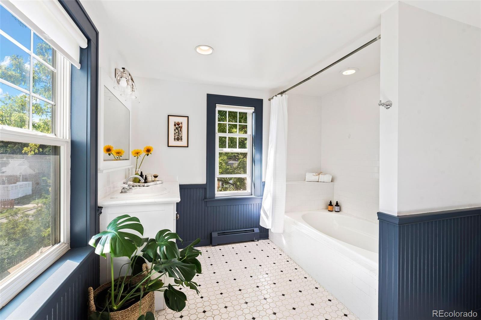 1205 Niagara Street Denver, CO 80220 - Photo 20 of 38 a bath room with a window and a dining table