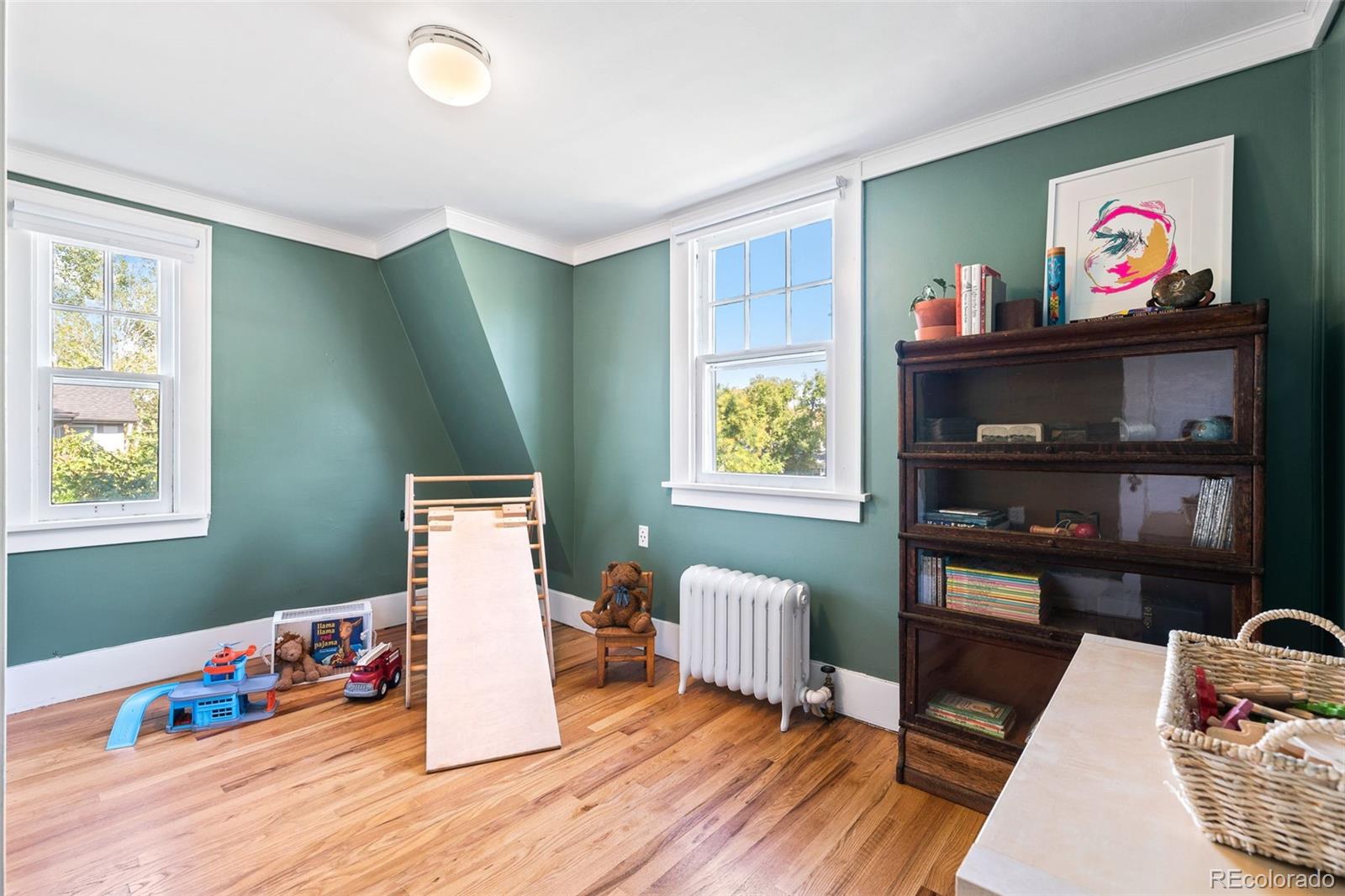 1205 Niagara Street Denver, CO 80220 - Photo 23 of 38 a bed room with furniture and painting on the wall
