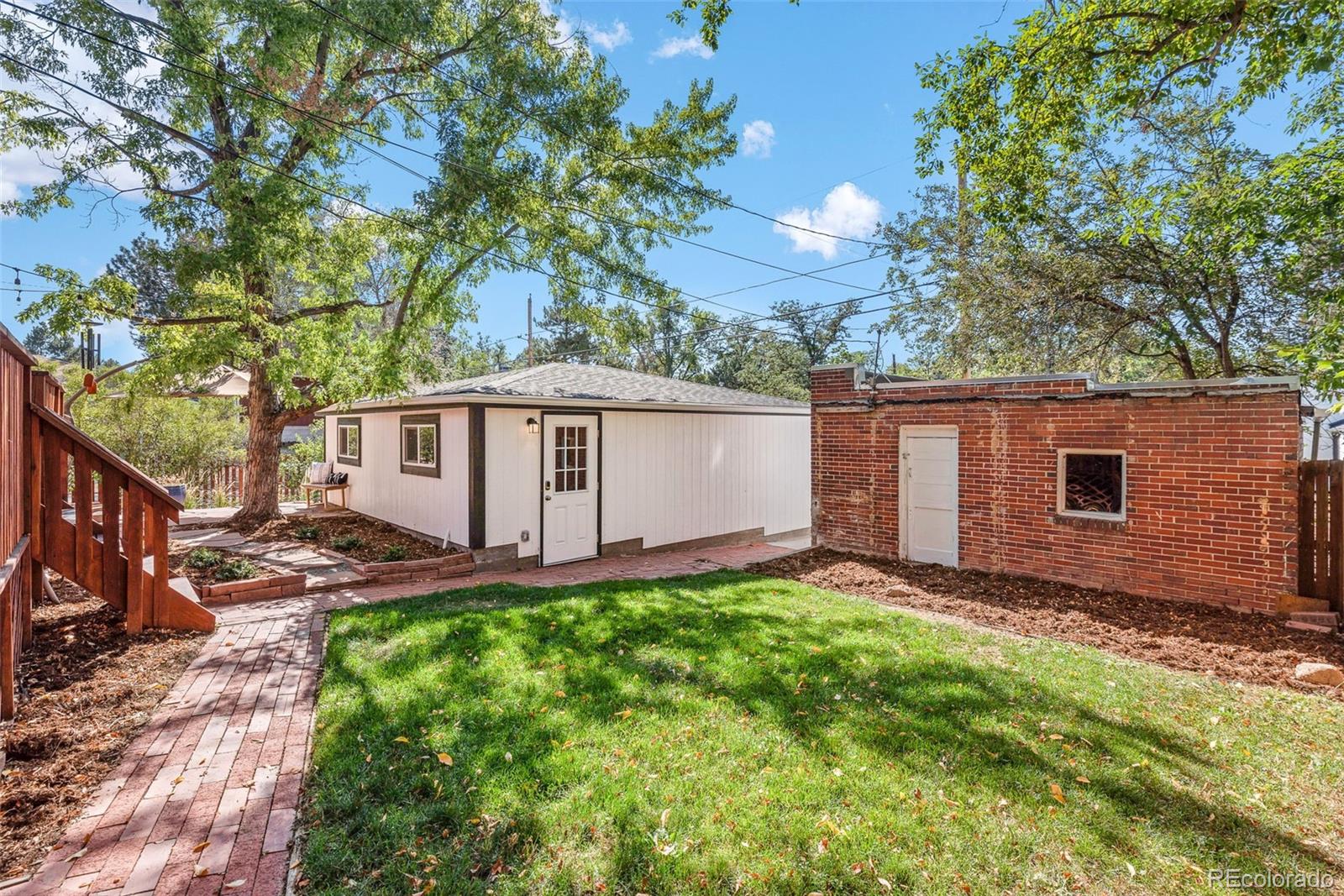1205 Niagara Street Denver, CO 80220 - Photo 35 of 38 a view of a backyard with a large tree