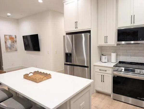 a kitchen with a stove a microwave a refrigerator a sink and a stove