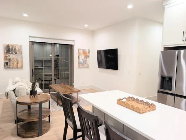 a dining room with furniture and a flat screen tv