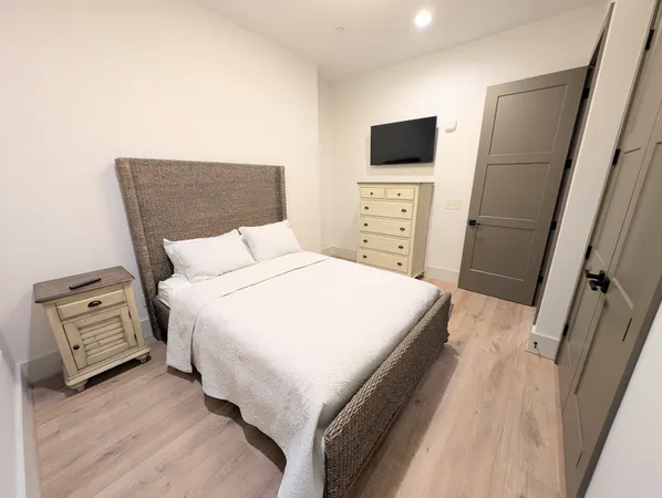 a bedroom with a bed and a television