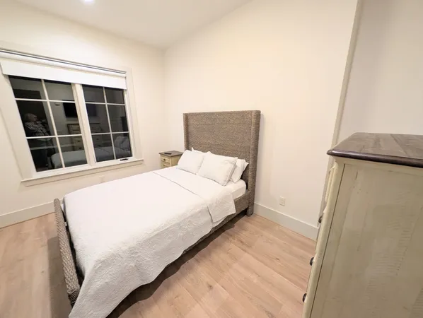 a large white bed in a small room