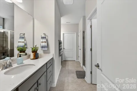 a bathroom with a sink a mirror and a shower