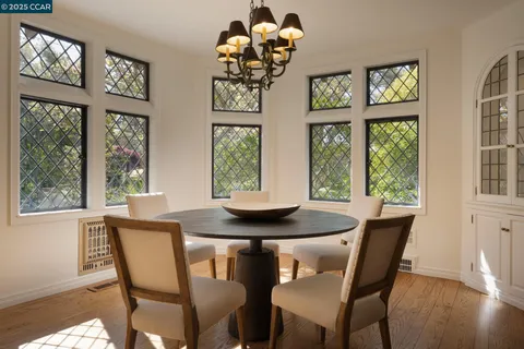 a living room with furniture a fireplace and a large window