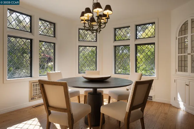 a living room with furniture a fireplace and a large window