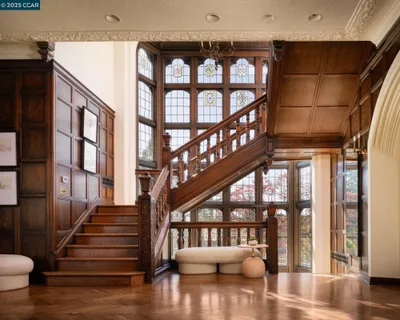 a bedroom with furniture and a large window