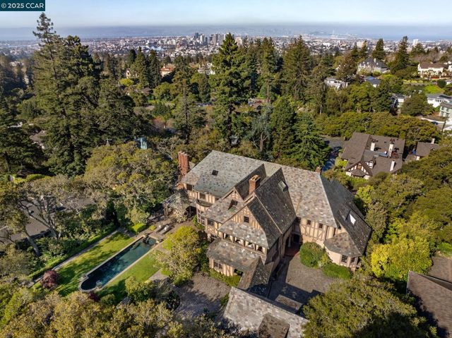 an aerial view of house with yard swimming pool and lake view