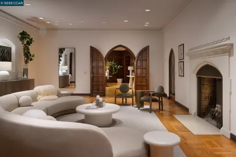 a dining room with furniture and large windows