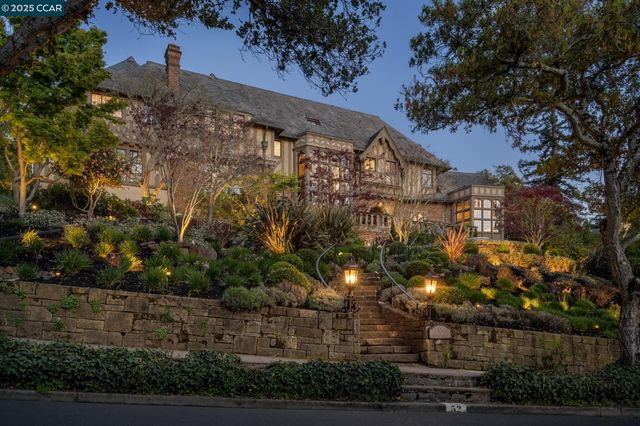 a view of house with yard and outdoor seating