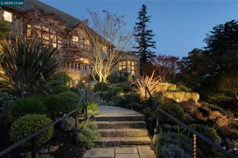 a house view with a sitting space fire pit and outdoor space