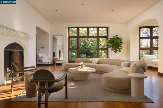 a living room with furniture and floor to ceiling windows