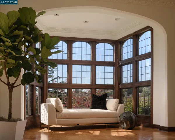a dining room with furniture and large windows