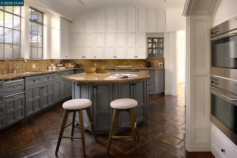 a view of a dining room with furniture a chandelier and wooden floor