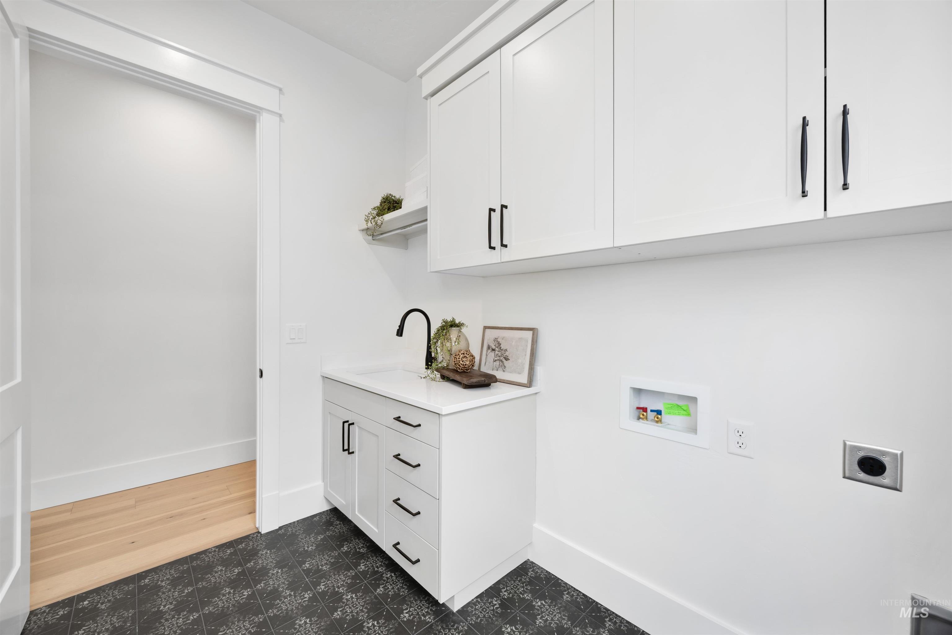 1034 East Escalation Street Meridian, ID 83642 - Photo 27 of 40 Laundry room featuring electric dryer hookup, washer hookup, and cabinet space