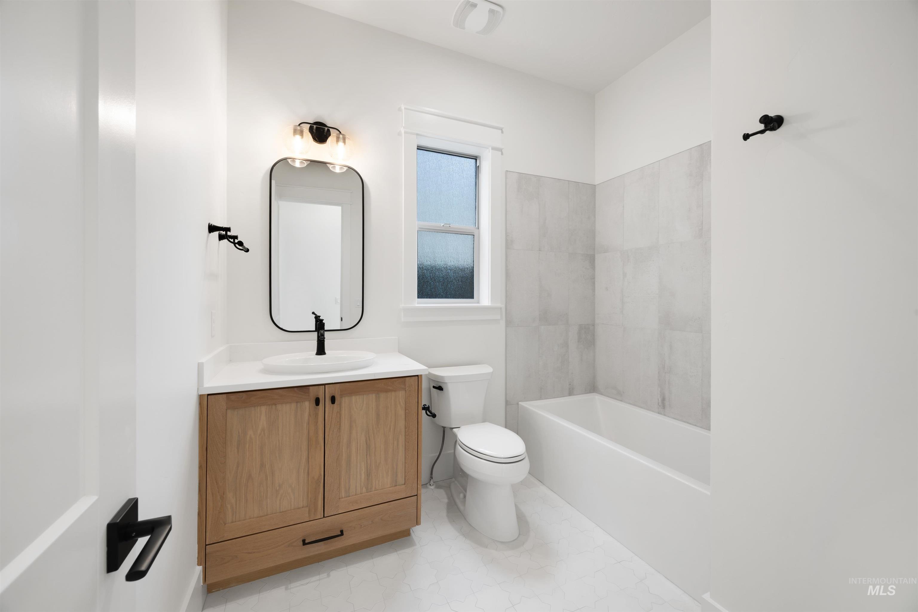 1034 East Escalation Street Meridian, ID 83642 - Photo 3 of 40 Full bathroom featuring vanity and shower combination