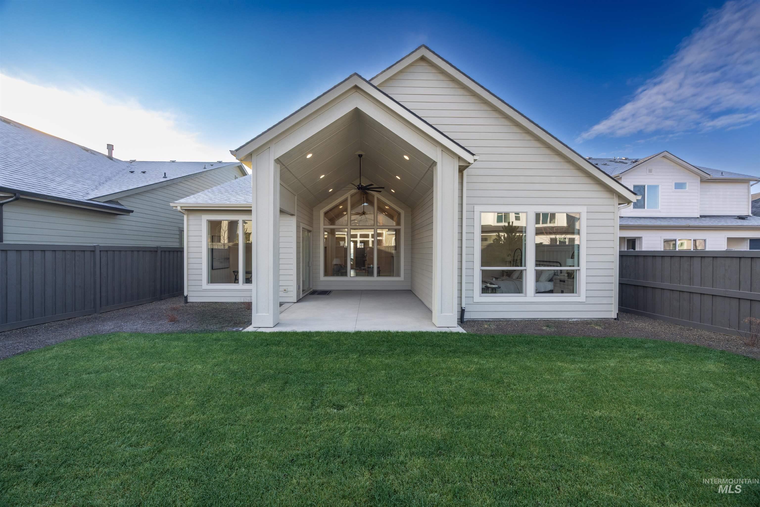 1034 East Escalation Street Meridian, ID 83642 - Photo 35 of 40 Rear view of property featuring a ceiling fan, a fenced backyard, and a patio