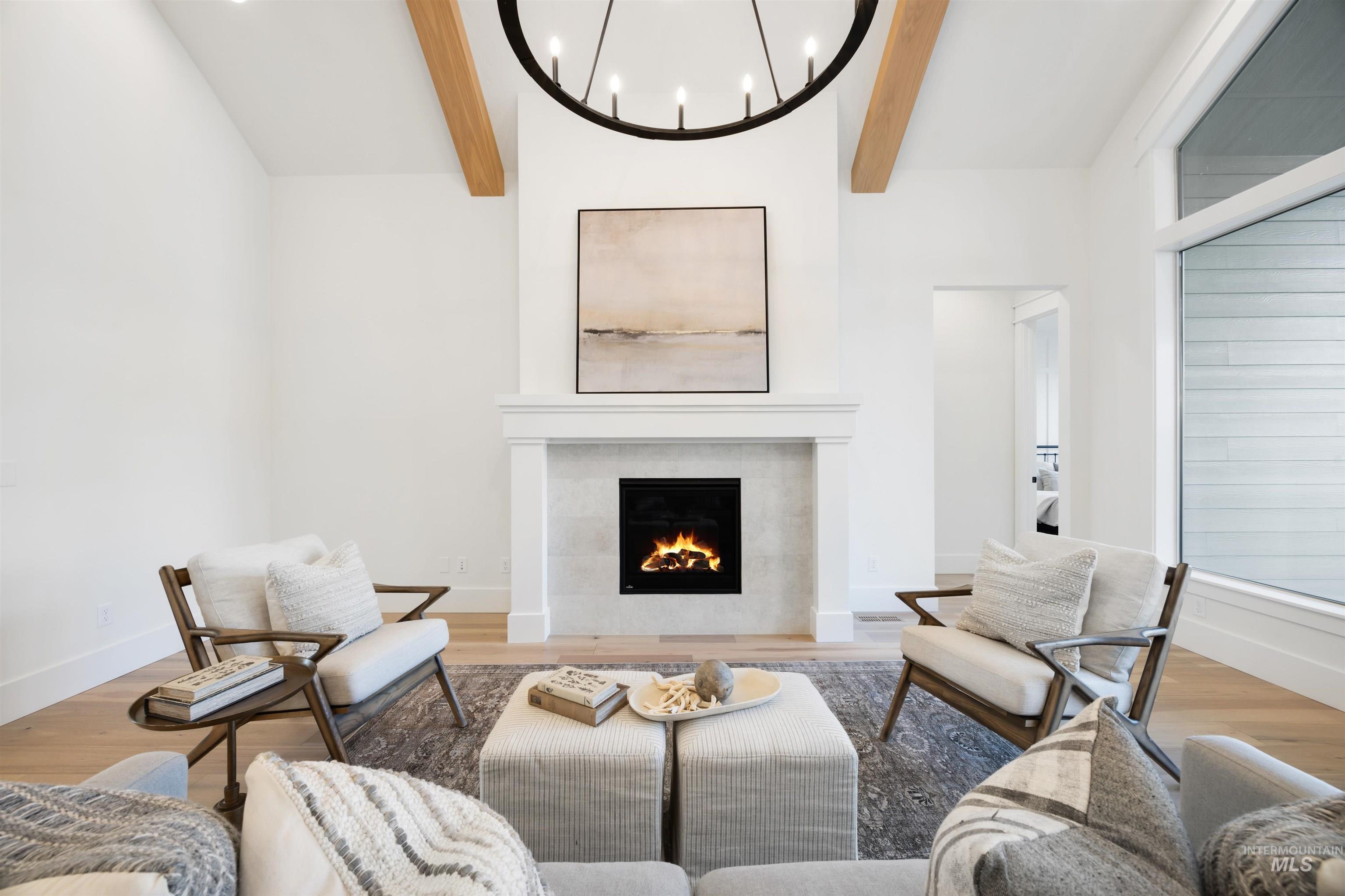 1034 East Escalation Street Meridian, ID 83642 - Photo 7 of 40 Living area with wood finished floors, a fireplace, and a chandelier