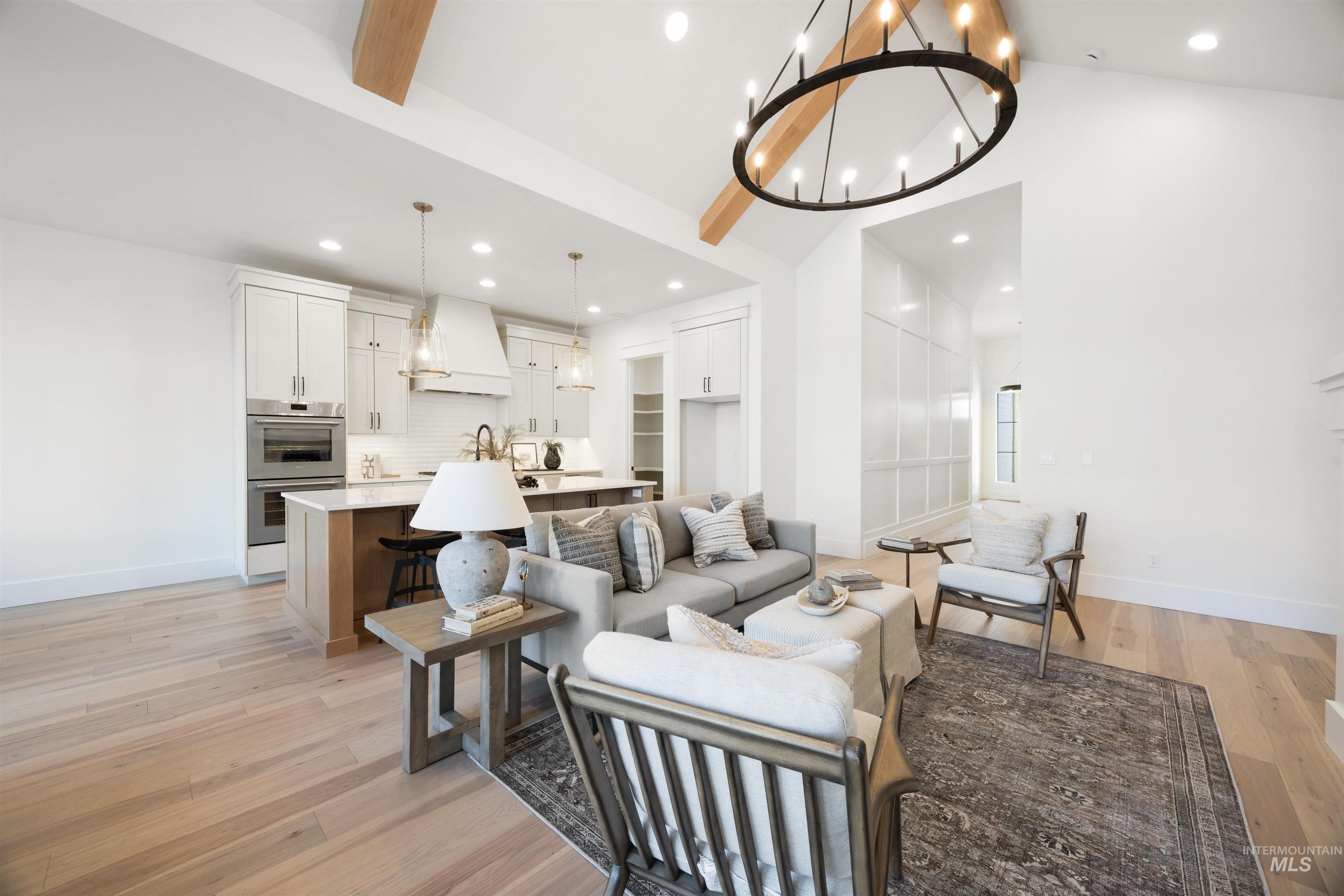 1034 East Escalation Street Meridian, ID 83642 - Photo 8 of 40 Living room featuring beamed ceiling, a chandelier, light wood-type flooring, high vaulted ceiling, and recessed lighting