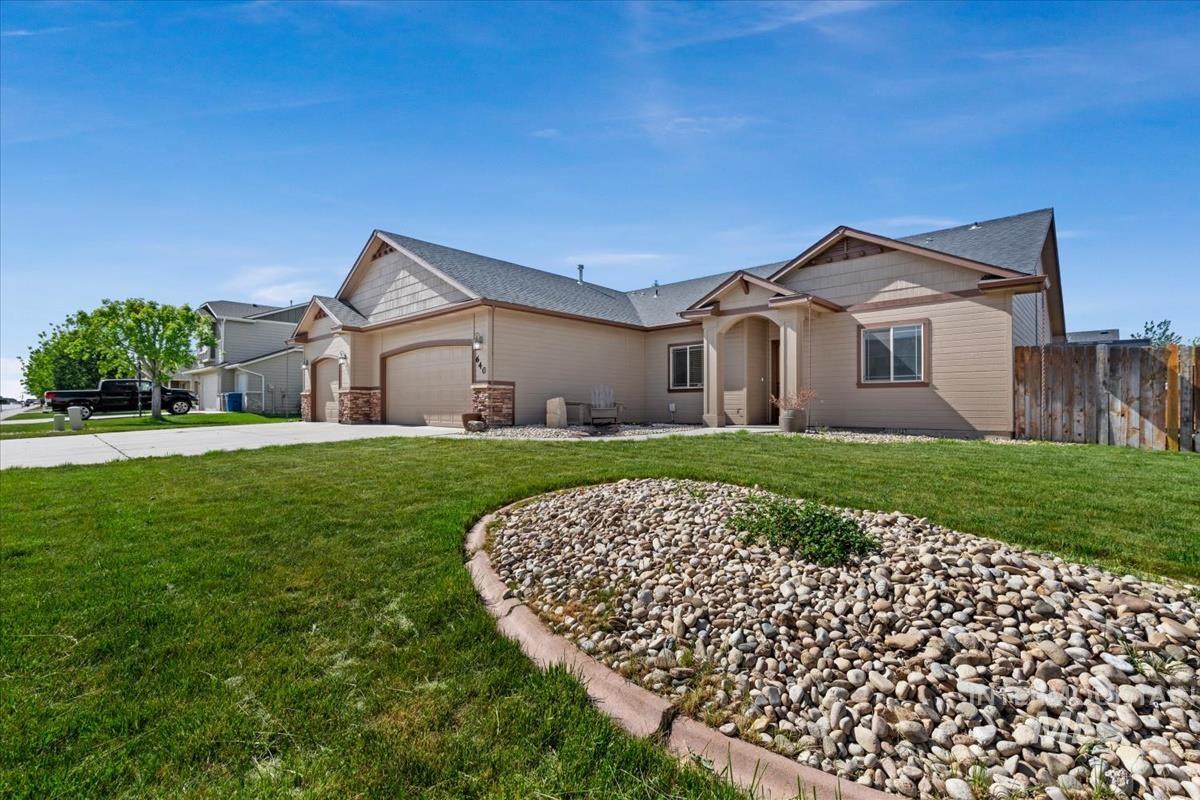 640 Southwest Miner Street Mountain Home, ID 83647 - Photo 2 of 35 Spacious single-story residence featuring a two-car garage, stone accents on the facade, and a covered entry
