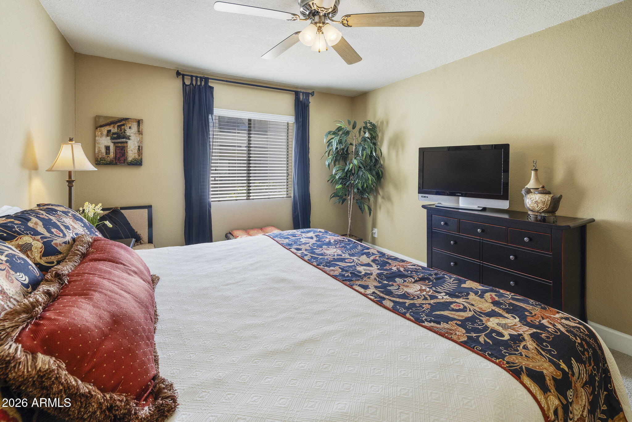 3825 East Camelback Road, Unit 126 Phoenix, AZ 85018 - Photo 10 of 28 a bedroom with a bed and a flat screen tv