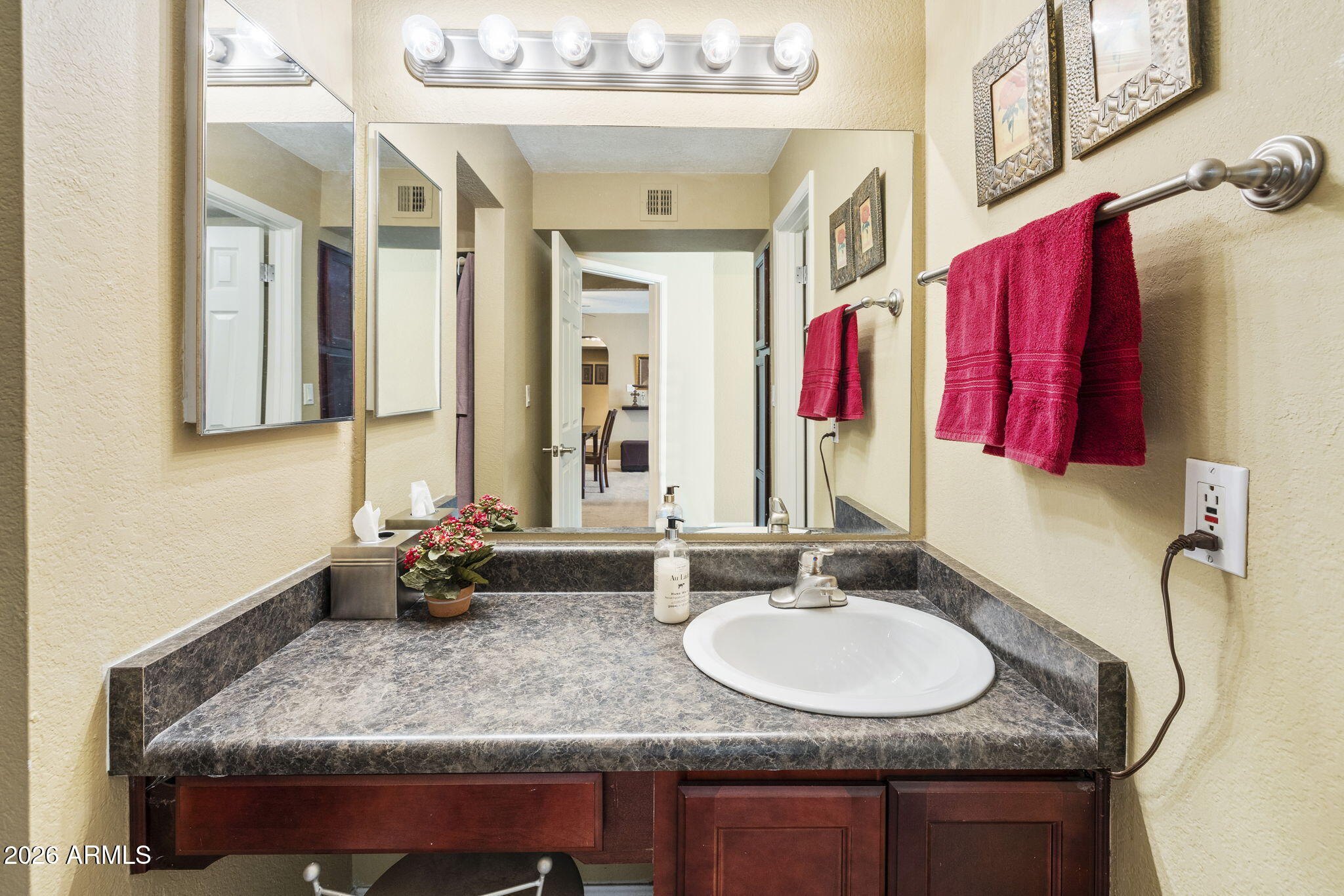 3825 East Camelback Road, Unit 126 Phoenix, AZ 85018 - Photo 14 of 28 a bathroom with a granite countertop sink and a mirror