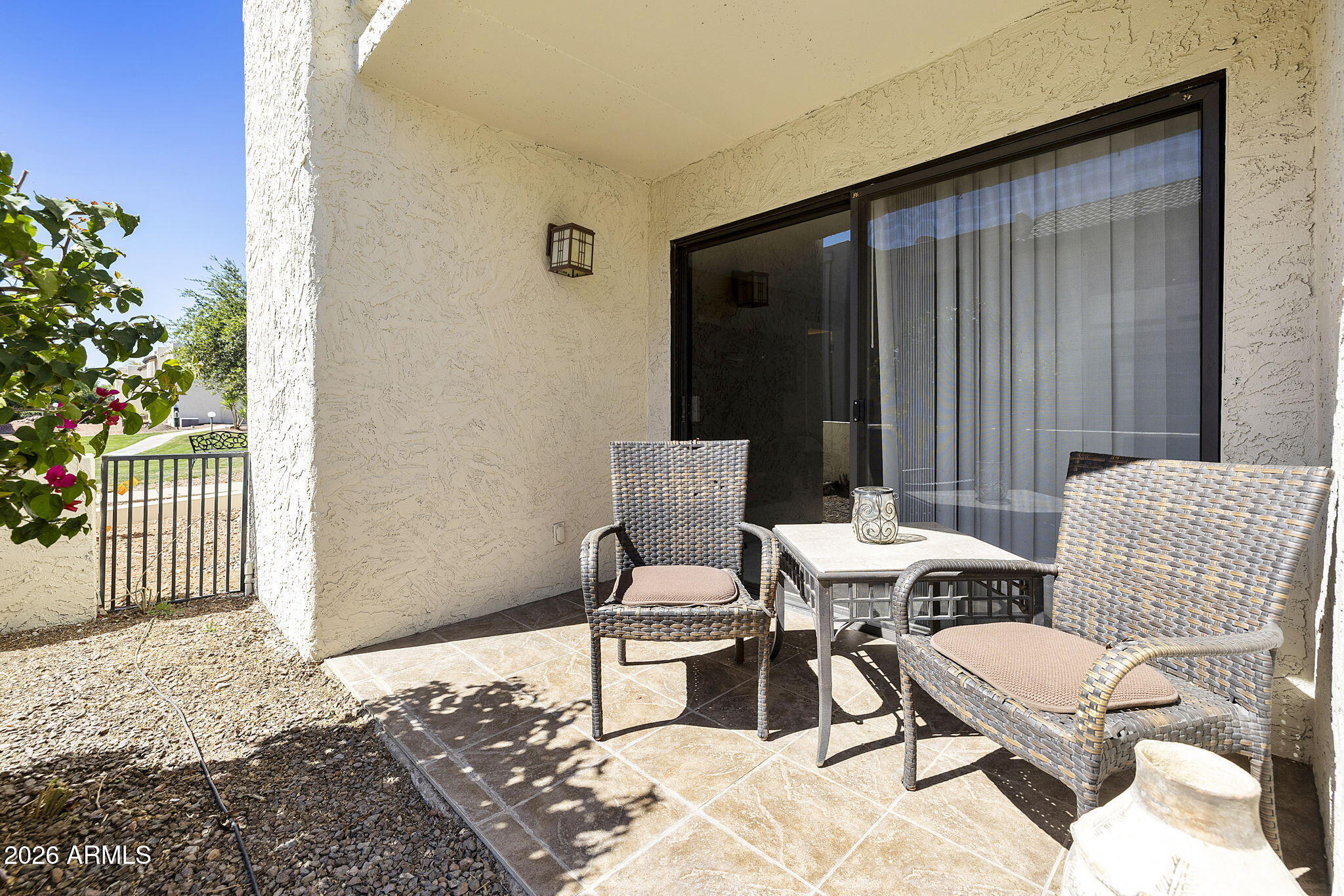 3825 East Camelback Road, Unit 126 Phoenix, AZ 85018 - Photo 18 of 28 a balcony with chairs and a potted plant