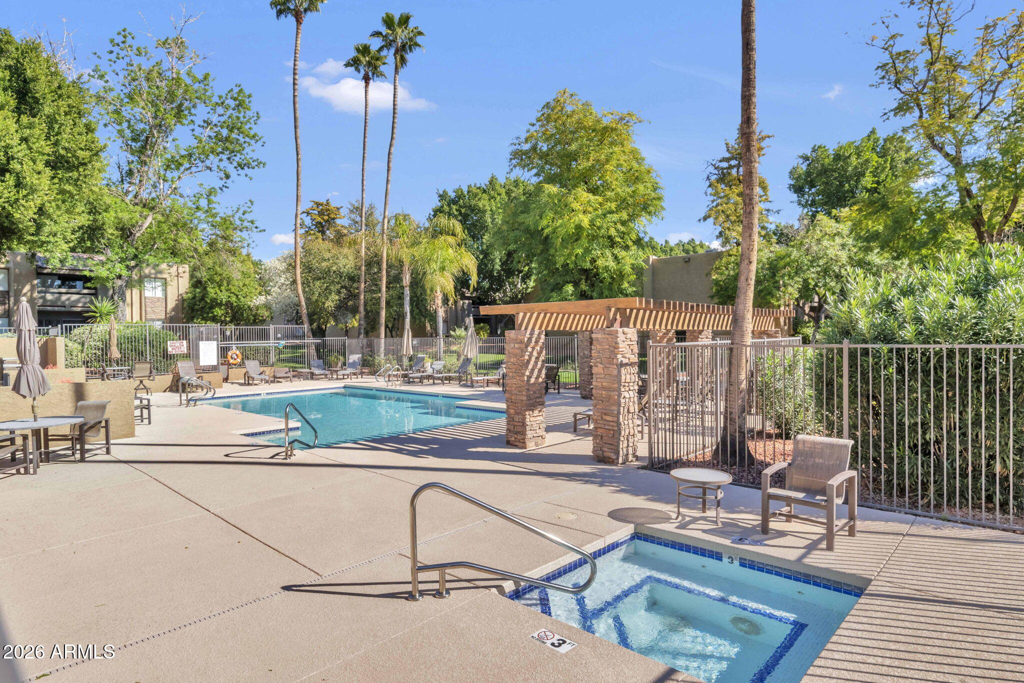 3825 East Camelback Road, Unit 126 Phoenix, AZ 85018 - Photo 19 of 28 a view of a patio with a table and chairs and potted plants