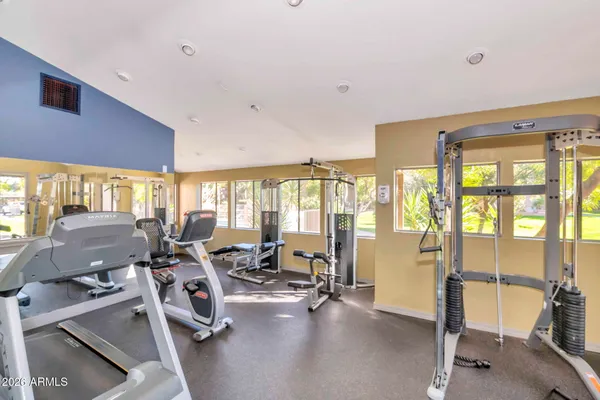 a view of a patio with a table and chairs and potted plants