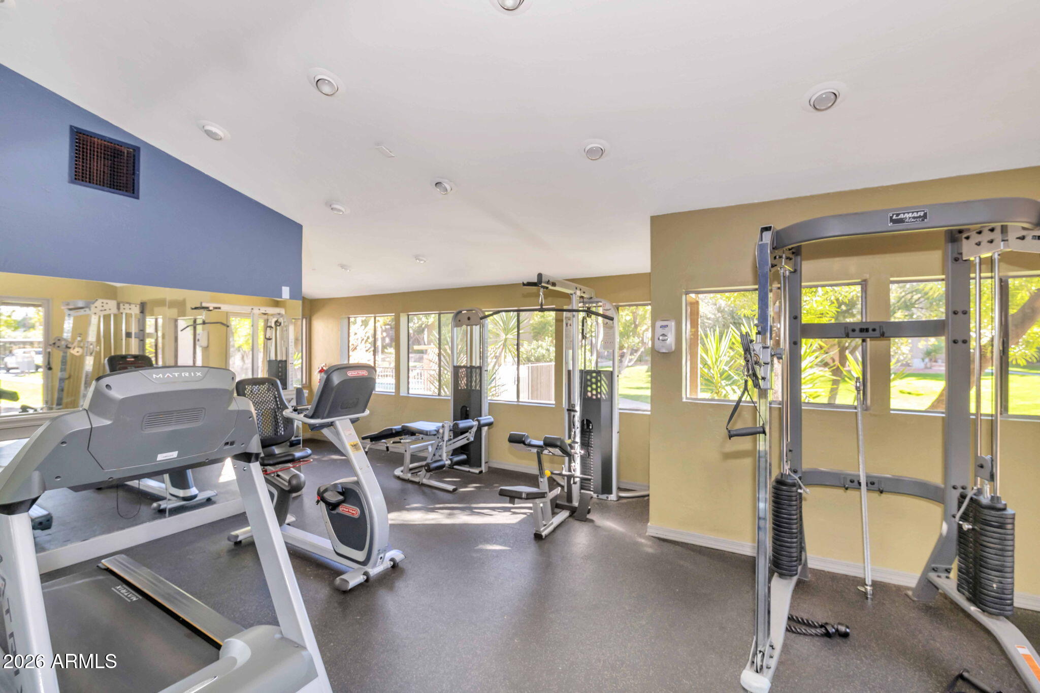 3825 East Camelback Road, Unit 126 Phoenix, AZ 85018 - Photo 21 of 28 a view of a room with gym equipment and floor to ceiling window