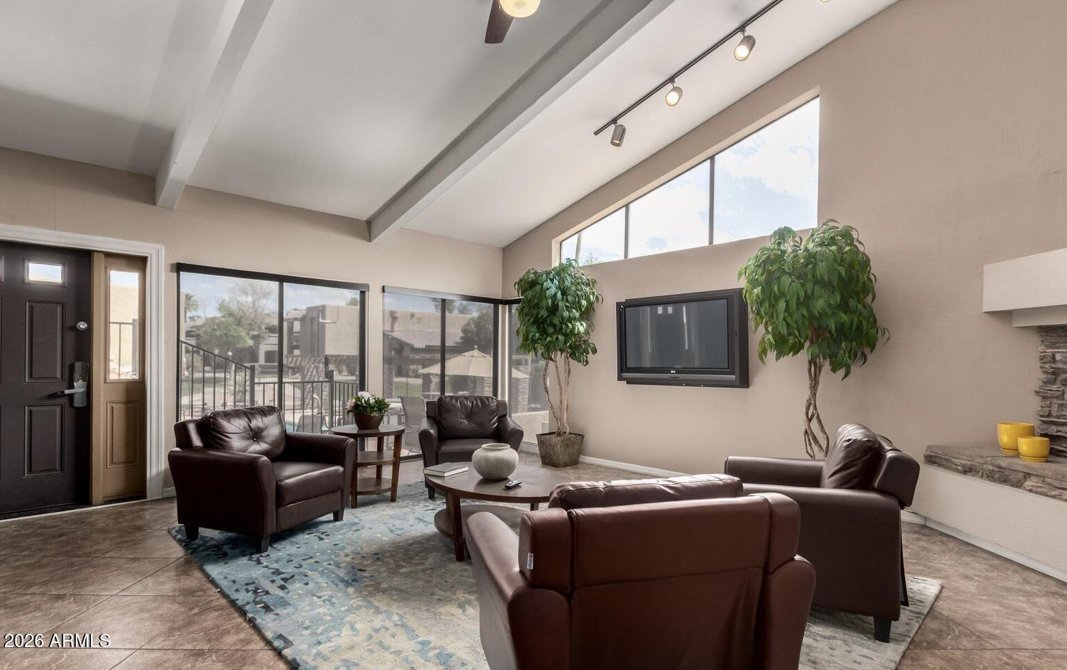 3825 East Camelback Road, Unit 126 Phoenix, AZ 85018 - Photo 24 of 28 a living room with furniture and a floor to ceiling window