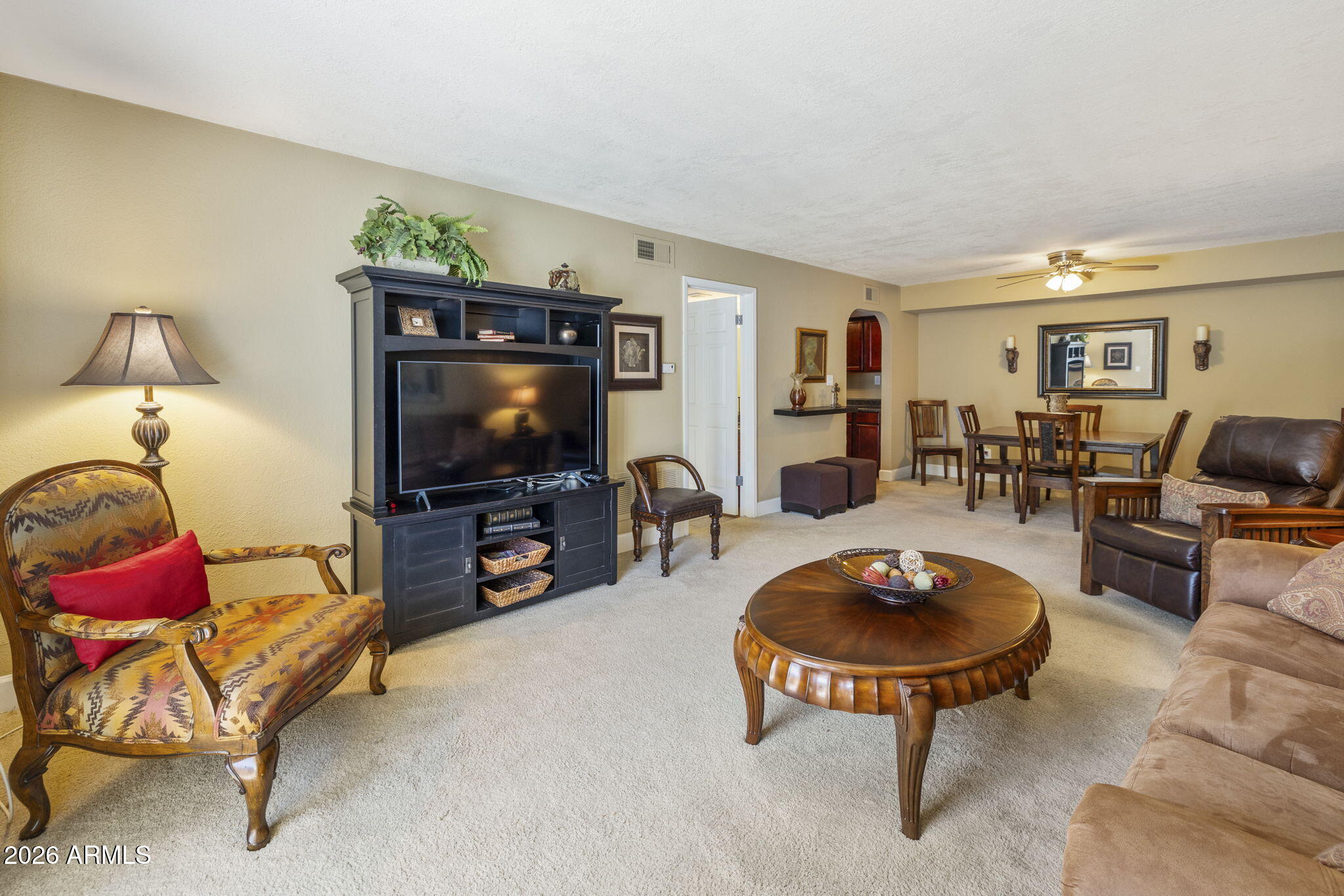 3825 East Camelback Road, Unit 126 Phoenix, AZ 85018 - Photo 2 of 28 a living room with furniture and a flat screen tv