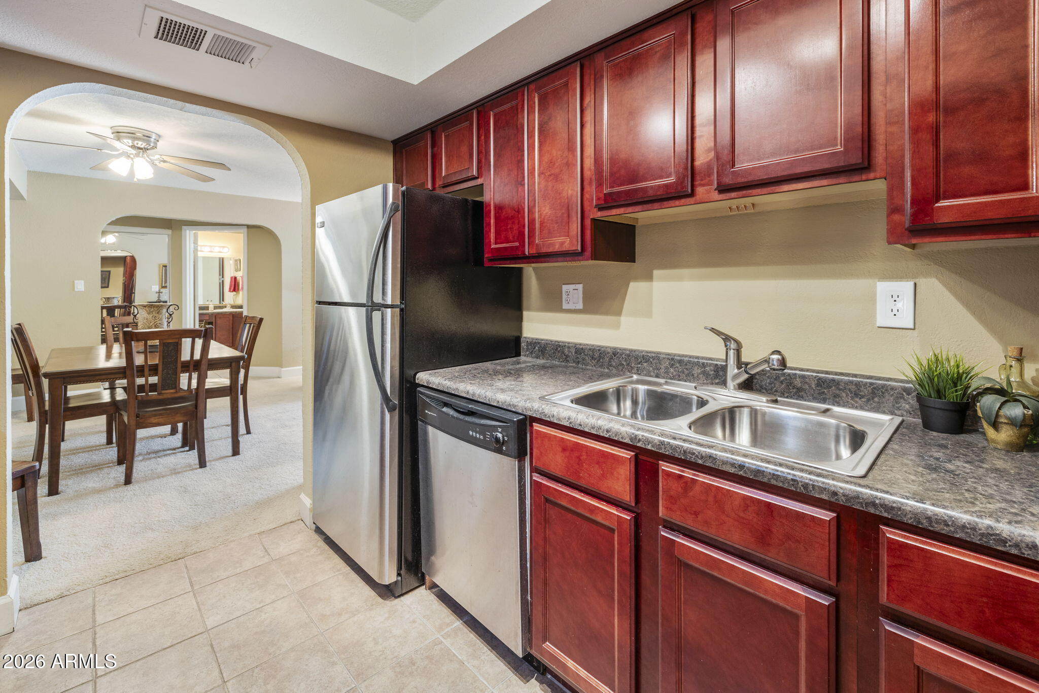3825 East Camelback Road, Unit 126 Phoenix, AZ 85018 - Photo 8 of 28 a kitchen with stainless steel appliances granite countertop a sink stove and cabinets