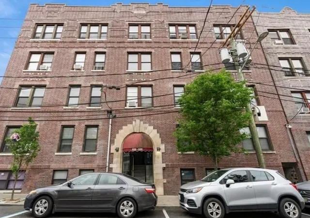 a front view of a building with parking space