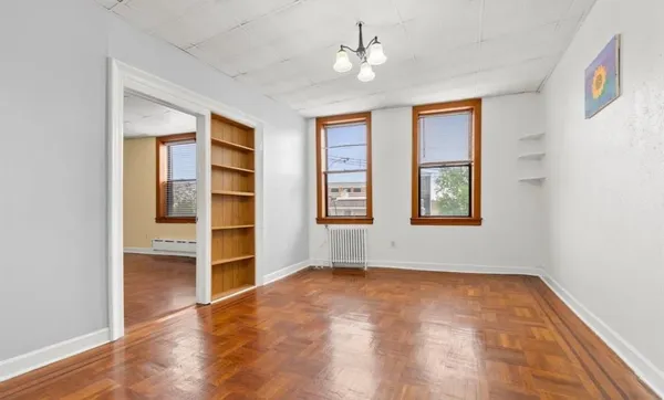 wooden floor in an empty room with a window