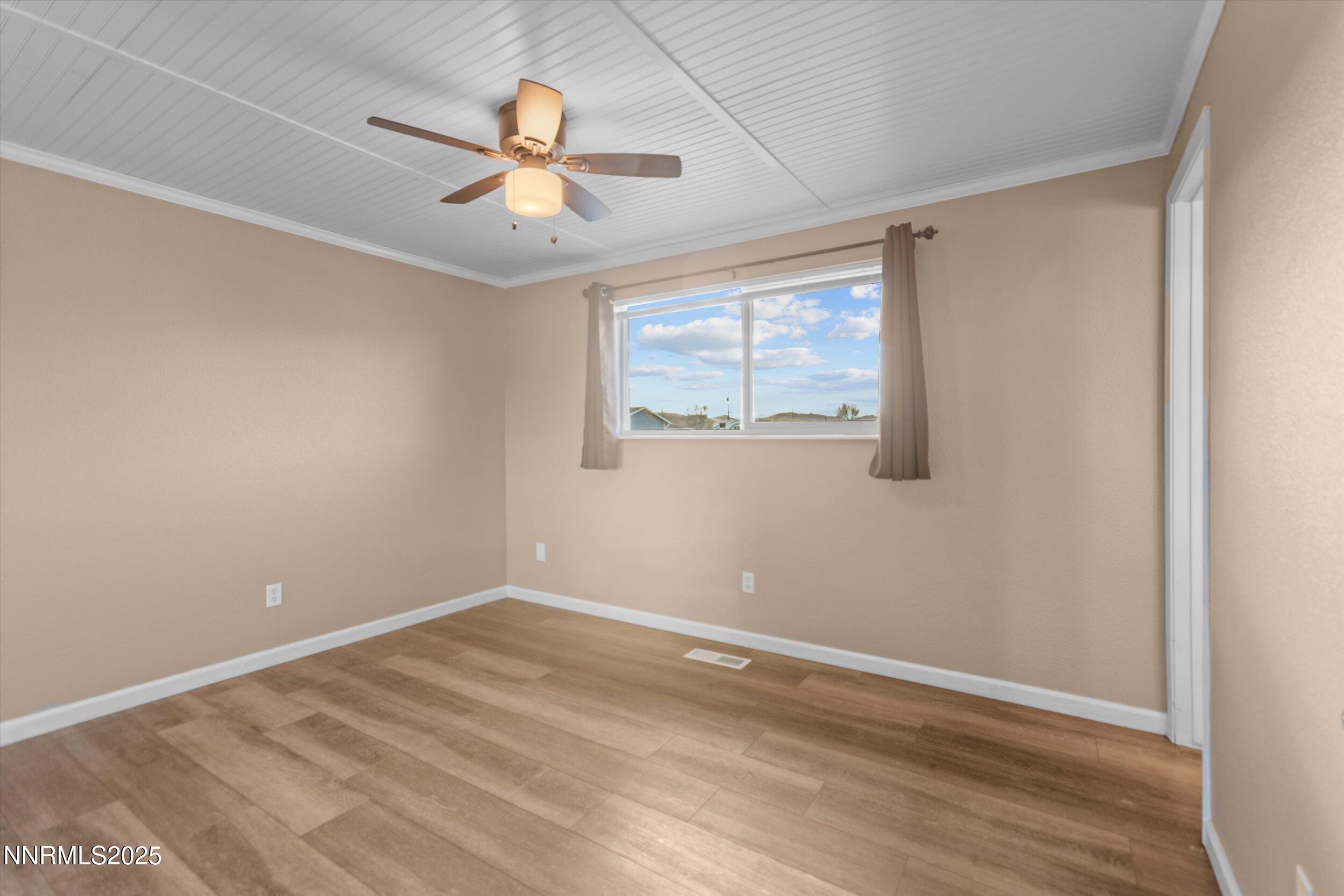 11567 Tupelo Street Reno, NV 89506 - Photo 11 of 32 wooden floor in an empty room with a window