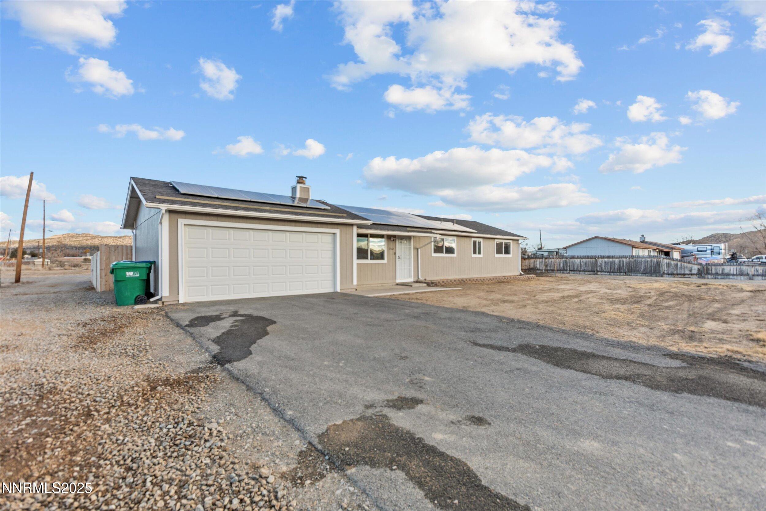 11567 Tupelo Street Reno, NV 89506 - Photo 25 of 32 a front view of a house with a yard and garage