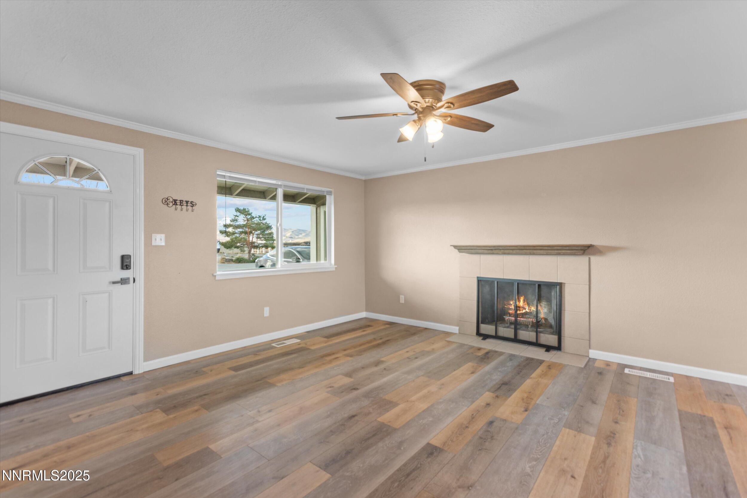 11567 Tupelo Street Reno, NV 89506 - Photo 3 of 32 a view of an empty room with a window and a fireplace