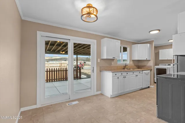 a kitchen with granite countertop a stove a sink and a refrigerator